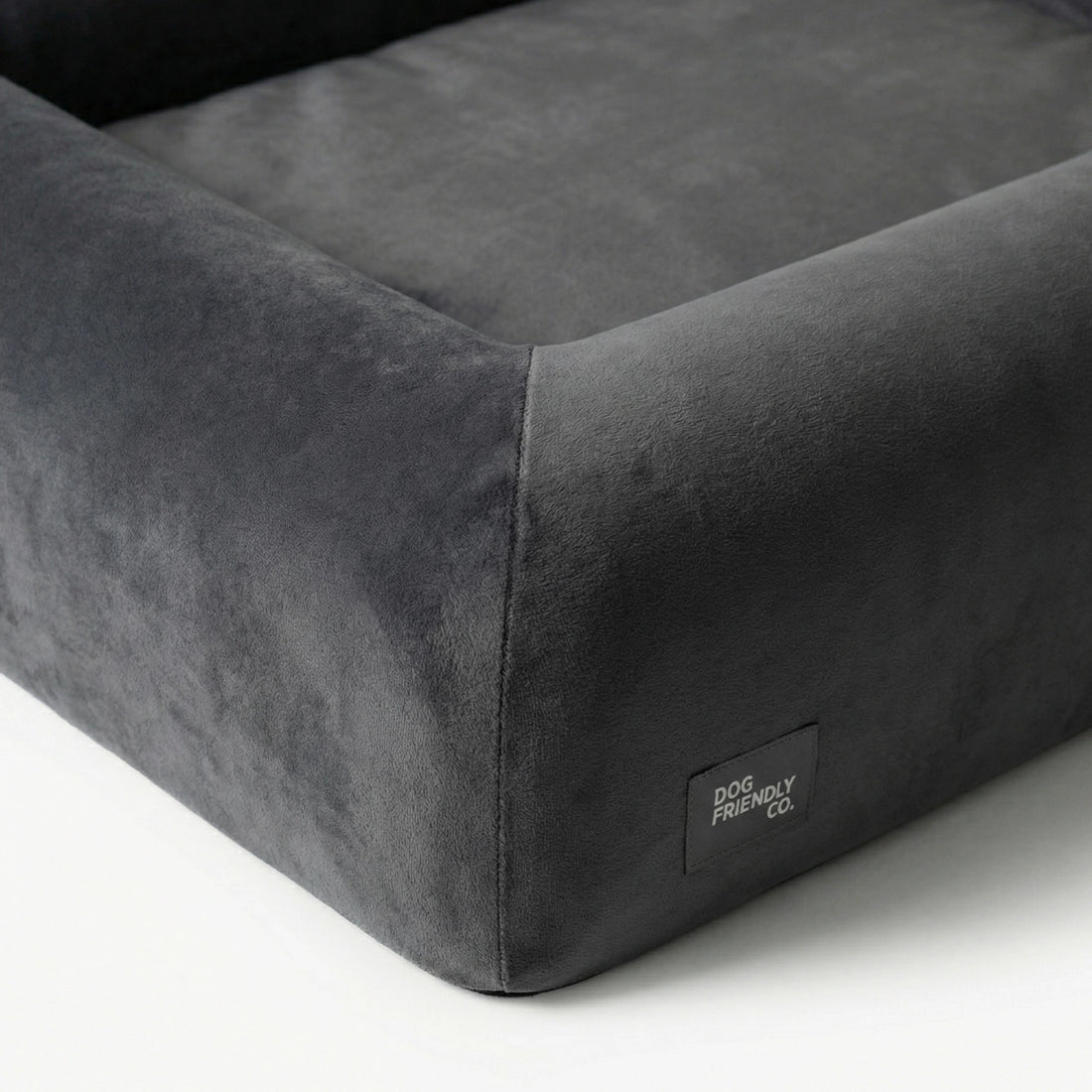 Close-up of the Charcoal orthopedic memory foam dog bed showing the soft outer cover, raised sides and reinforced stitching.